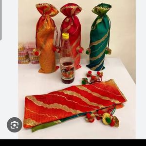 Festive handcrafted <b>potli</b> bottle <b>bags</b> set featuring elegant silk-blend fabric with rich zari wave patterns - Product Image 1
