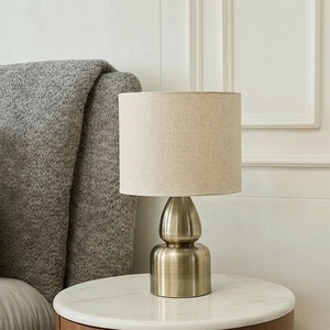 Aurora Sculpted Metal Table <b>Lamp</b> with Linen Drum Shade Antique Brass Finish Soft Ambient Lighting for Elegant Interiors - Product Image 5