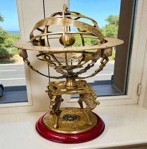 Premium brass armillary sphere globe on winged lion pedestal base with built-in <b>compass</b>, available at wholesale prices. - Product Image 1