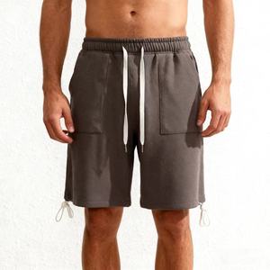 Short cargo ample respirant en coton 100% pour homme, taille mi-haute, couleur unie, avec cordon de serrage et ourlet élastique, personnalisable avec logo - Product Image 1