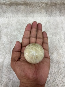 Cream moonstone <b>sphere</b> with soft ivory coloring subtle sheen rounded contours smooth polishing and refined mineral appeal - Product Image 1