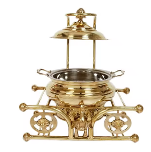 Stunning and unique, this round brass chafing dish sits <b>on</b> an artistic frame with <b>wheel</b> details, available at wholesale prices. - Product Image 2