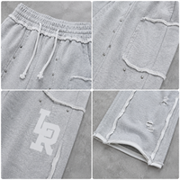 Pantalon de survêtement ample perlé gris chiné en coton à jambe large avec cordon de serrage, bords bruts et poches plaquées, style streetwear OEM ODM