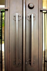A rust-resistant, manually operated traditional wrought-iron double door set, featuring an arched design and intricate patterns. - Product Image 6