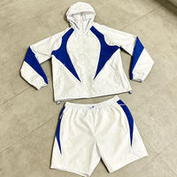 Ensemble de survêtement unisexe blanc et bleu imprimé avec blocs de couleur, col rond, fermeture éclair, manches courtes, short, coupe-vent, écologique, design 2-en-1