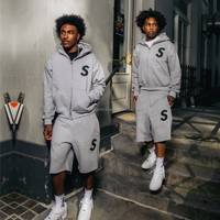 Ensemble de survêtement streetwear d'hiver personnalisé, épais et respirant, avec sweats à capuche à cordon de serrage et pantalons de survêtement évasés à effet délavé à l'acide, imprimé