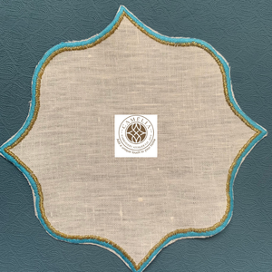 Linen cocktail napkin with soft azure <b>edges</b> and golden trim, star-bloom shape bringing a gentle yet striking table accent - Product Image 1