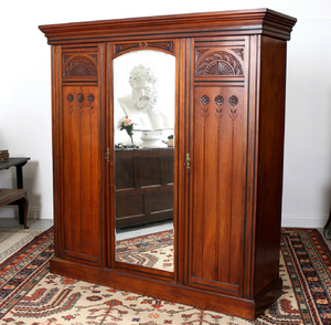A traditional carved wooden <b>wardrobe</b> featuring a center <b>mirror</b> <b>door</b> and floral embellishments, available at wholesale prices. - Product Image 1