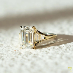 Elegant <b>Emerald</b> Cut Lab Grown Diamond <b>Ring</b> With Tapered Side Stones And Luxurious Gold Band Design - Product Image 3