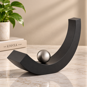 Urna Escultural en Forma de Arco de Metal Negro con Diseño de Curva en Forma de Media Luna, Detalle de Esfera Rodante y Soporte Distintivo para Cenizas Conmemorativas - Product Image 1