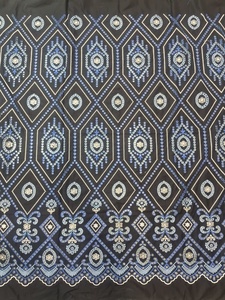 Tissu en coton noir de jais en gros avec broderie géométrique losanges bleu roi, bleu ciel et blanc et bordure pour vêtements - Product Image 1