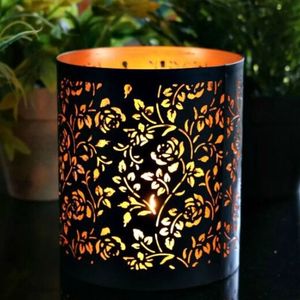 Portavelas votivo de metal hecho a mano, diseñado para crear un cálido brillo ambiental que realza la decoración festiva y calma el hogar. - Product Image 1