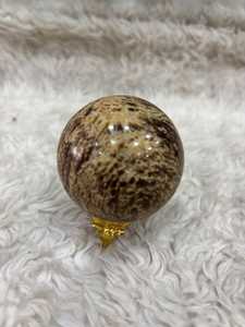 Banded aragonite <b>sphere</b> with layered mineral patterns earthy tones polished round form natural texture and distinctive - Product Image 1