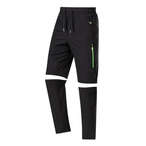 Pantalones de Senderismo Negros Convertibles con Bolsillos con Cremallera y Detalles Verdes para Actividades al Aire Libre - Product Image 1