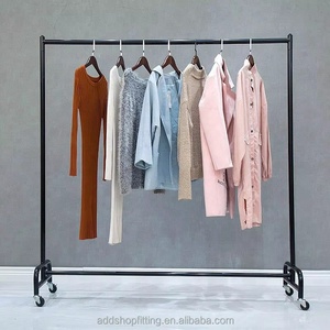 Gold Movable Wheel Rail Stand <b>Clothes</b> Display Rack With Wooden Hangers And Multiple Garments Shown - Product Image 3