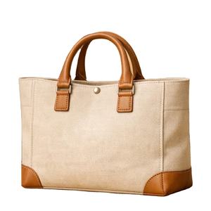 Bolso tote de lona y cuero con diseño estructurado, asas superiores y refuerzos en las esquinas - Product Image 1