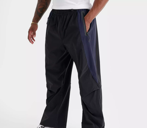 Pantalon de survêtement blanc surdimensionné pour homme, coupe large, avec empiècements latéraux contrastants noirs et détails de passepoil, taille à cordon de serrage, 100% coton, vente en gros sur mesure - Product Image 1