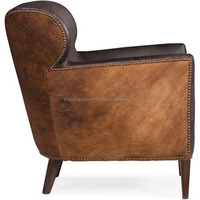 Fauteuil en cuir de luxe avec structure robuste, assise confortable et rembourrée, design élégant, parfait pour le salon ou la salle de séjour.