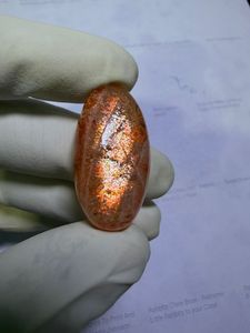 พลอยซันสโตนสีส้มธรรมชาติทรงหลังเบี้ย ประกายทองและเปลี่ยนสีได้ เหมาะสำหรับแหวน จี้ และงานออกแบบเครื่องประดับระดับพรีเมียม - Product Image 4