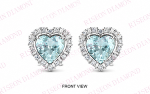Elegant heart shaped blue diamond <b>stud</b> earrings with halo of round and baguette white diamonds in luxurious 18K white gold desig - Product Image 3