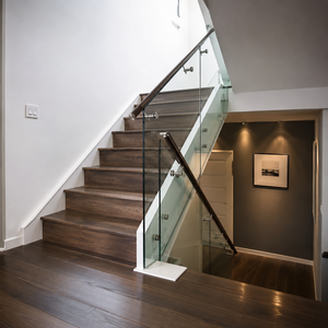 Modern glass stair <b>railing</b> with dark wood handrail for luxury home villa and hotel interiors featuring clear tempered glass pane - Product Image 2