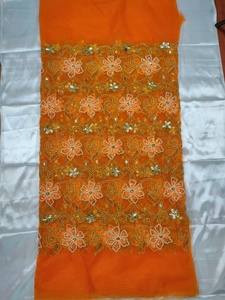 Tela de malla nigeriana naranja de Simply Stunning Fashion con encaje de red y patrón floral con intrincado trabajo de bordado para ropa de fiesta. - Product Image 1