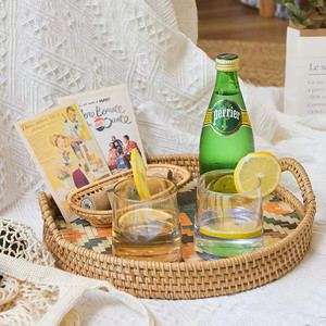 Round serving tray, a harmonious combination of rattan and natural bamboo. Features a handle. - Product Image 3