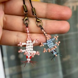 Porte-clés brodé artisanal avec des perles colorées et un design élégant, fabrication détaillée - Product Image 1