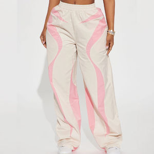 Pantalones de chándal holgados blancos de poliéster con cordón y logotipo personalizado para mujer, cortavientos de nailon, pantalones tipo paracaídas personalizados - Product Image 1