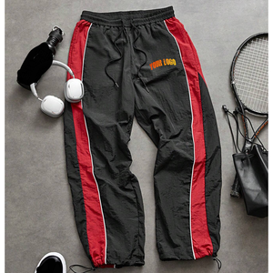 Pantalones de chándal de nailon con botones personalizados estilo urbano para hombre, venta al por mayor directa de fábrica, de pierna ancha acampanada, cortavientos - Product Image 1