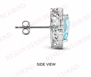 Elegant heart shaped blue diamond <b>stud</b> earrings with halo of round and baguette white diamonds in luxurious 18K white gold desig - Product Image 4