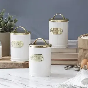 Set of four decorative metal kitchen canisters in varying sizes for stylish countertop food storage airtight lids - Product Image 2
