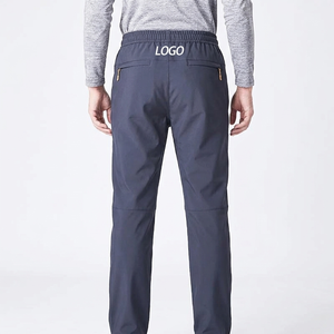 Pantalon de jogging décontracté pour homme en polyester bleu foncé à taille élastique, séchage rapide, avec poches et logo sur la jambe droite, idéal pour l'automne - Product Image 2