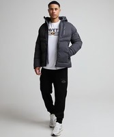 Veste matelassée à capuche noire pour homme, coupe-vent, fermeture éclair, polyester, manteau d'hiver décontracté, coupe régulière, couleur unie