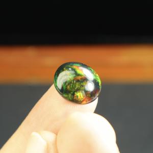 พลอยโอปอลสีดำธรรมชาติทรงรีขนาด 6.55 กะรัต ขัดเงา พร้อมแสงเล่นสี/แสงไฟ สำหรับทำเครื่องประดับ ขนาด 15x12 มม. - Product Image 5