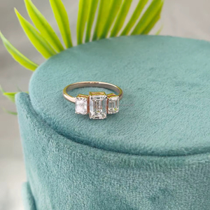 Emerald Cut Diamond Ring with Side <b>Stones</b> in Yellow Gold crafted for timeless elegance clean lines and a sophisticated luxury - Product Image 1