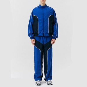 Ensemble de survêtement pour homme, bleu, à blocs de couleur, en polyester tricoté, respirant, col montant, style sportif décontracté, coupe-vent, en vente en ligne - Product Image 1