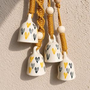 Cloche murale en céramique faite à la main avec imprimé cœur jaune et gris et perles en bois, décoration rustique de Noël - Product Image 1