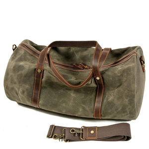 Olive Canvas Duffle Bag With Brown Leather Handles And Zipper Closure For Travel And Weekend Use - Product Image 2