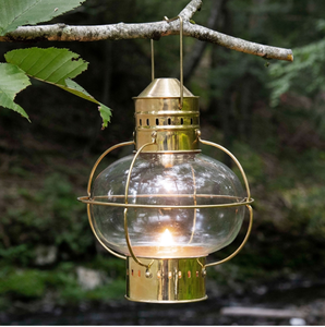 Hanging polished <b>brass</b> globe <b>lantern</b> with protective cage for outdoor use, available at wholesale prices. - Product Image 1