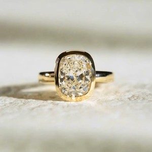 Elegant <b>Cushion</b> Cut Diamond Ring In Yellow Gold Bezel Setting <b>For</b> Modern Brides - Product Image 1