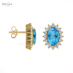 Fournisseur en gros de bijoux : Boucles d'oreilles clous en or 14K avec halo de diamants et topaze bleue suisse taille ovale 6x4mm, fermoir push-back, bijoux minimalistes pour femme - Product Image 2