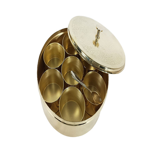 A beautiful handcrafted brass masala box with multiple compartments and a spoon organizing storing various spices in the <b>kitchen</b> - Product Image 1