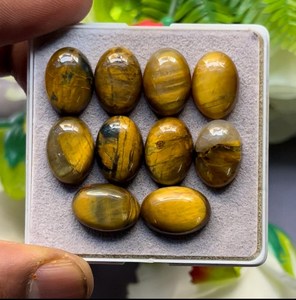 Cabujones ovalados de ojo de tigre natural pulidos con efecto ojo de gato para la fabricación de joyas - Product Image 1