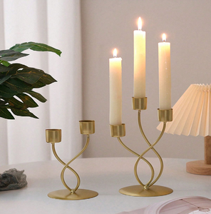 Elegant gold multi-tier candle holder with a twisted <b>ribbon</b> stem design. Perfect modern tabletop accent. Available at wholesale - Product Image 1