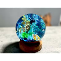 Modelos de bolas de cristal de resina epoxi, modelos de caracoles y edificios, modelos de delfines oceánicos