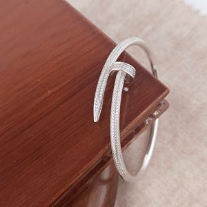 Bracelet jonc ouvert Revalia en argent sterling 925, motif croix de diamants, finition rhodiée, micro-pavé, design moderne, pour femme, idéal pour les soirées - Product Image 1