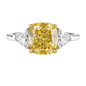 Luxurious three stone ring in 18K white gold with fancy yellow cushion diamond trillion side diamonds sleek minimal couture desi - Product Image 1