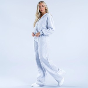 Nuevo conjunto de chándal de invierno para mujer con logo personalizado, 2 piezas, hombros caídos, capucha y pantalón jogger de pierna ancha a precios de mayorista - Product Image 1