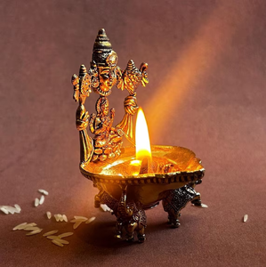 Ornate brass Kamakshi diya featuring detailed carvings of Goddess Lakshmi and <b>elephant</b> base feet, available at wholesale prices. - Product Image 1